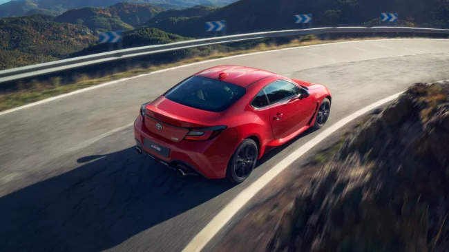 Essai voiture d'une toyota GR86 rouge sur une route de montagne